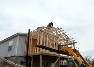 Carpenters on the roof of new building addition, exterior remodeling Pekin IL, exterior remodeling contractor Pekin IL, siding contractor Pekin IL, siding replacement Pekin IL, window installation Pekin IL, replacement windows Pekin IL, door installation Pekin IL, exterior doors Pekin IL, roofing contractor Pekin IL, roof replacement Pekin IL, gutter installation Pekin IL, gutter guards Pekin IL, soffit and fascia Pekin IL, home exterior renovation Pekin IL, exterior home improvement Pekin IL, Peoria area exterior contractor, residential siding contractor Pekin, residential roofing Pekin IL, energy efficient windows Pekin IL, vinyl siding installation Pekin IL, gutter replacement Pekin IL, roofing installation Pekin IL, window replacement contractor Pekin, curb appeal improvement Pekin IL, home value improvement Pekin IL, weather resistant siding Pekin IL, Midwest exterior remodeling, home insulation upgrades Pekin IL, exterior contractor Central Illinois, home remodeling Pekin IL